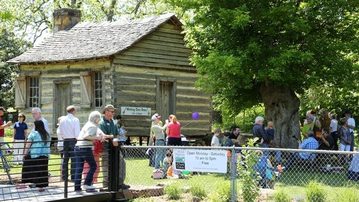 Members of the Shiloh Museum in front of the old log cabin on the Shiloh Museum campus. 