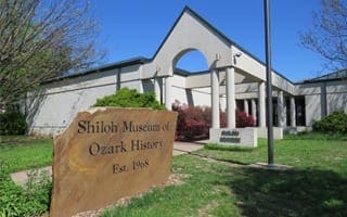 The main exhibit hall of the Shiloh Museum of Ozark History, a white, modern-style building. 