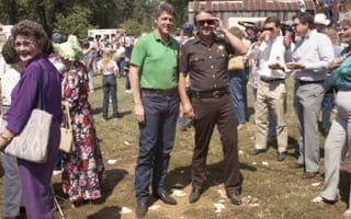 A crowd in a field at an event in the late 1960s or early 1970s.