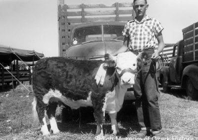 Phillip Cates of Mayfield with his grand champion steer at a livestock show, Washington County, 1956.