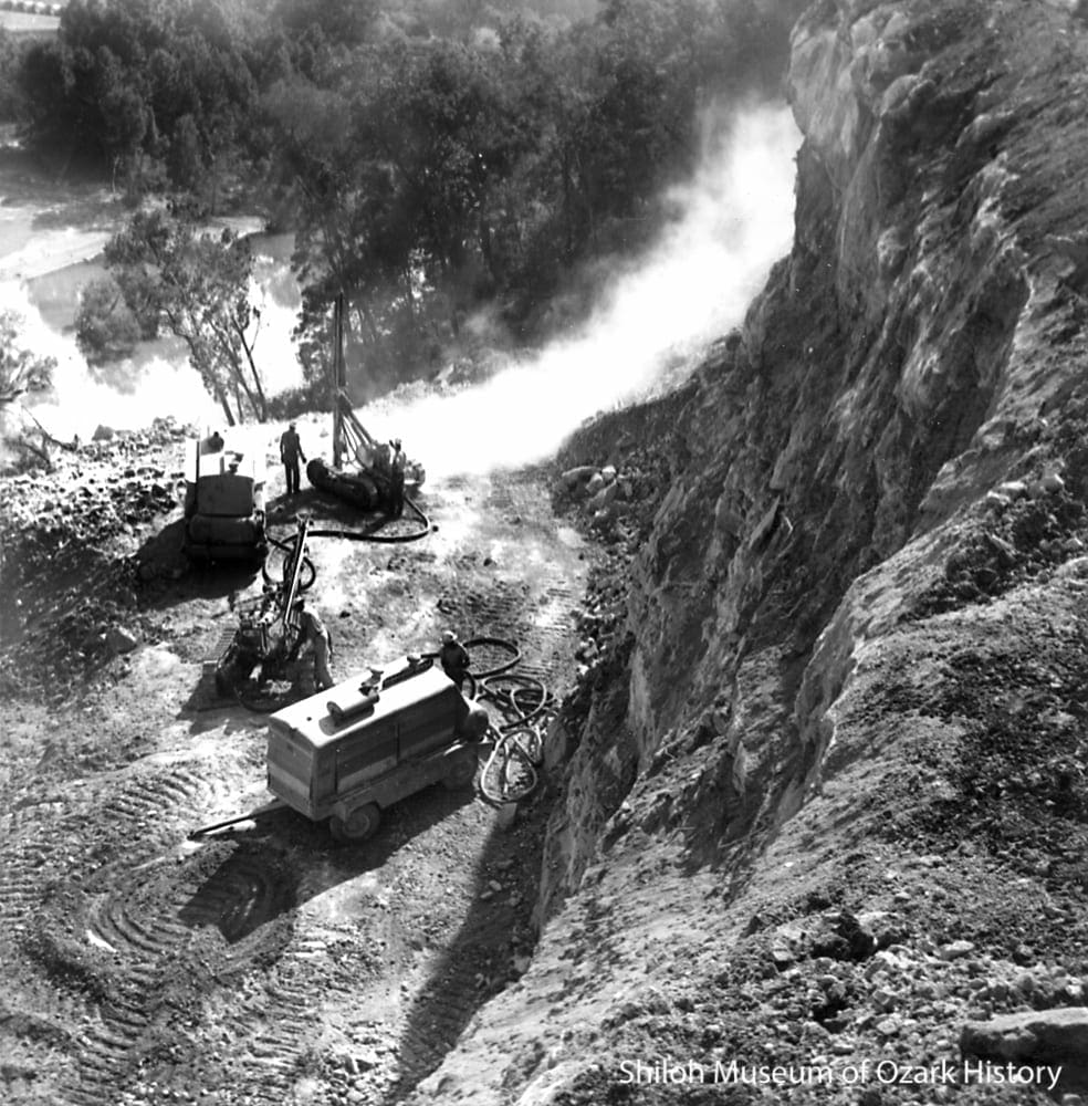 Preparing a bluff ledge for the concrete mixing plant, early 1961.