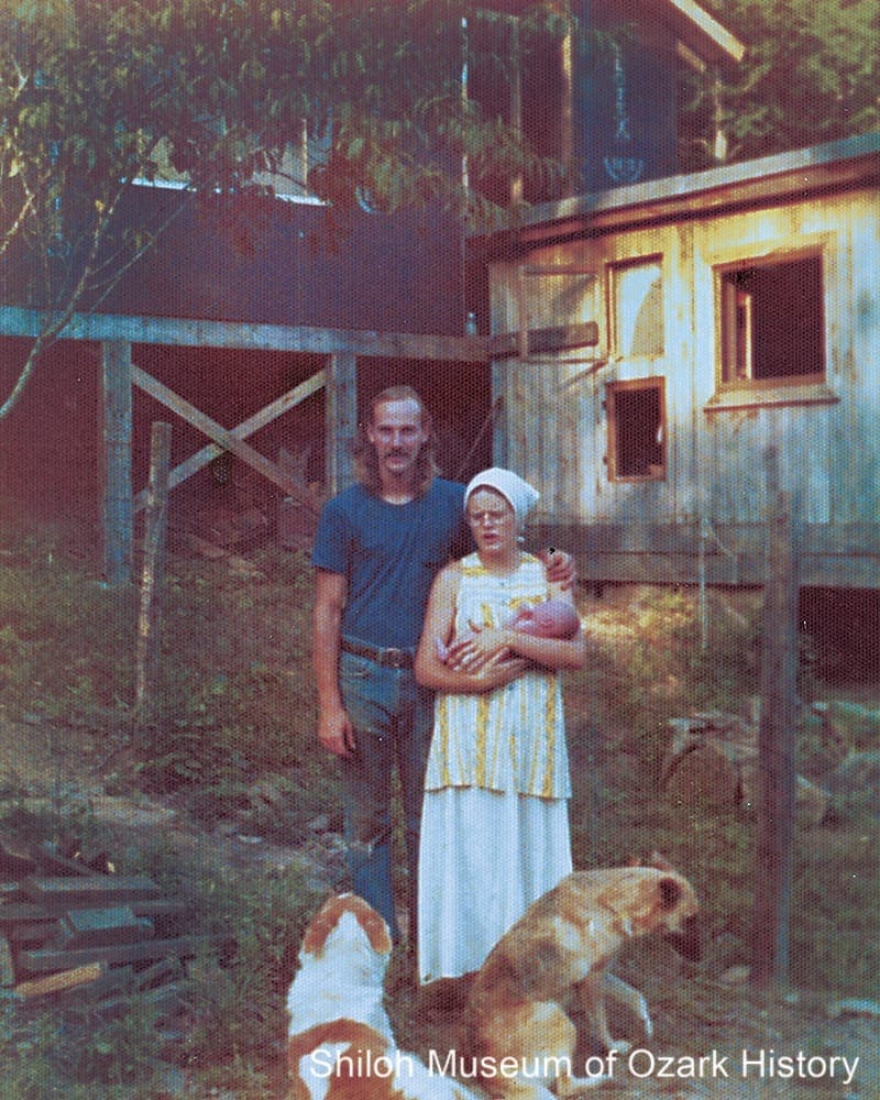 Bruce and Joan Johnson with baby Jesse, Burrdog (left), and Sparky at their home under construction near St. Paul, Arkansas, July 24, 1974.
