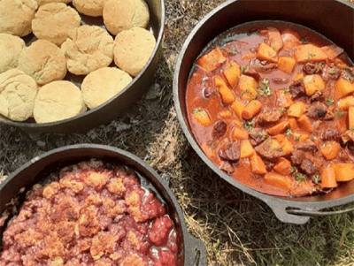 Image of three Dutch ovens containing baked biscuits, stew and possibly hash.