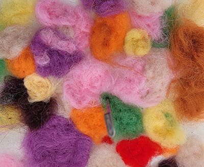 Photo of colorfully dyed balls of fabric before being processed.