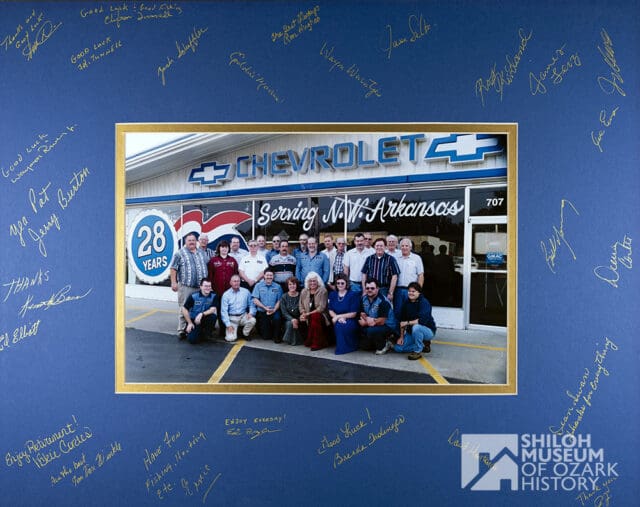 😀 Happy 📷 #PhotoIDFriday! Did you ever buy a 🚗 car at Pat Henry Chevrolet in Springdale? If so, one of these people may have helped you. We don’t know when, but it looks like the photo was taken for someone’s retirement, and it’s quite possible that the signatures on the frame are of the people in the photo. Can you tell us when this was taken and match up any of the names to the people in the photo? Thank you!
Photo is from the Shiloh Museum’s Earlene Brown Henry Collection (S-2014-13-8).
#SpringdaleArkansas #PatHenryChevrolet #ArkansasOzarks