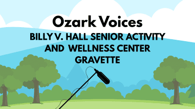 Event graphic titled "Ozark Voices" over bold text reading "BILLY V. HALL SENIOR ACTIVITY AND WELLNESS CENTER GRAVETTE." Below the text, an illustration shows a shotgun microphone on a boom pole set against a scenic backdrop of green trees, grassy hills, and blue rolling mountains under a light blue cloudy sky.